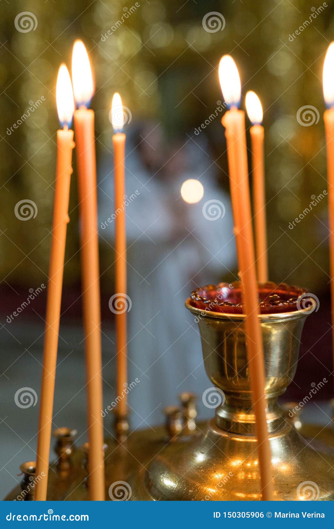 Orange Candles Stand in an Iron Candlestick and the Fire is Lit Stock