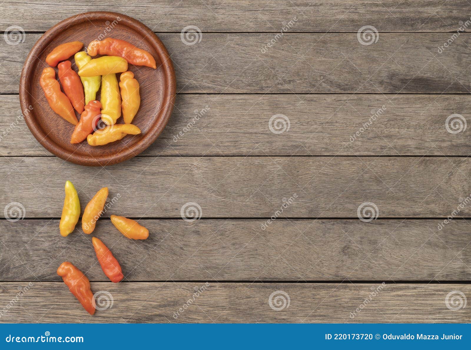 orange cheiro smell,scent peppers on a plate over wooden table with copy space