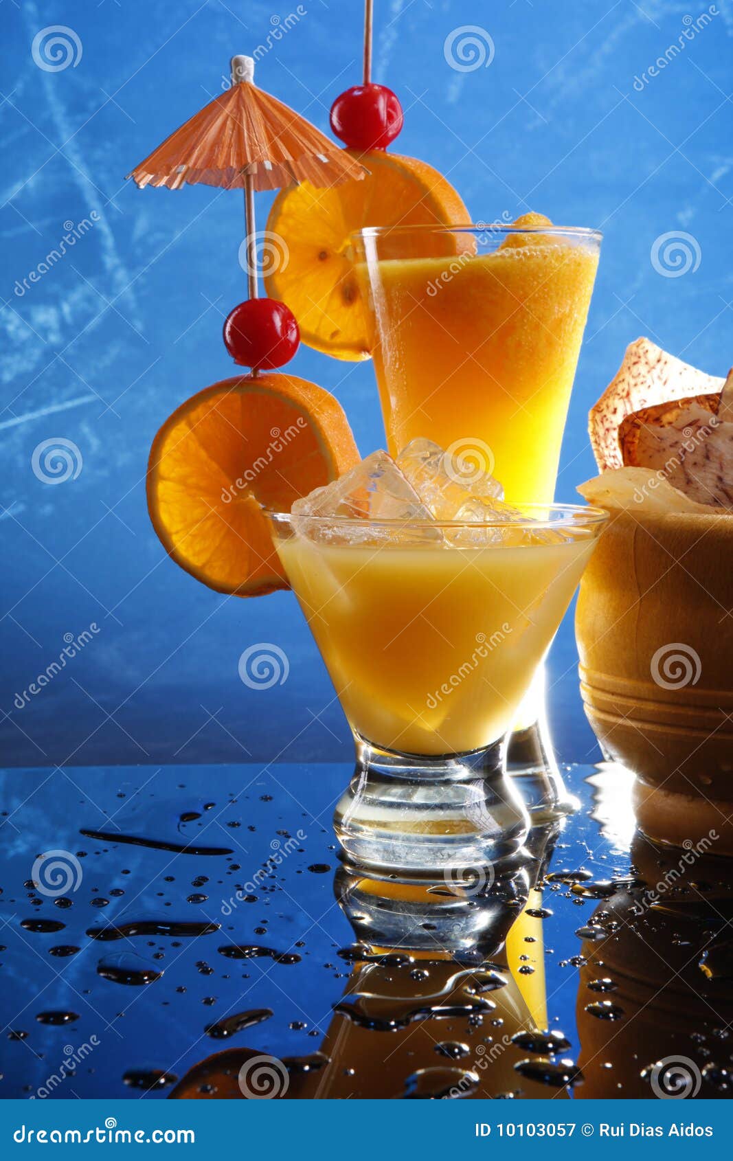 Orange cocktails on blue stock image. Image of mango 10103057