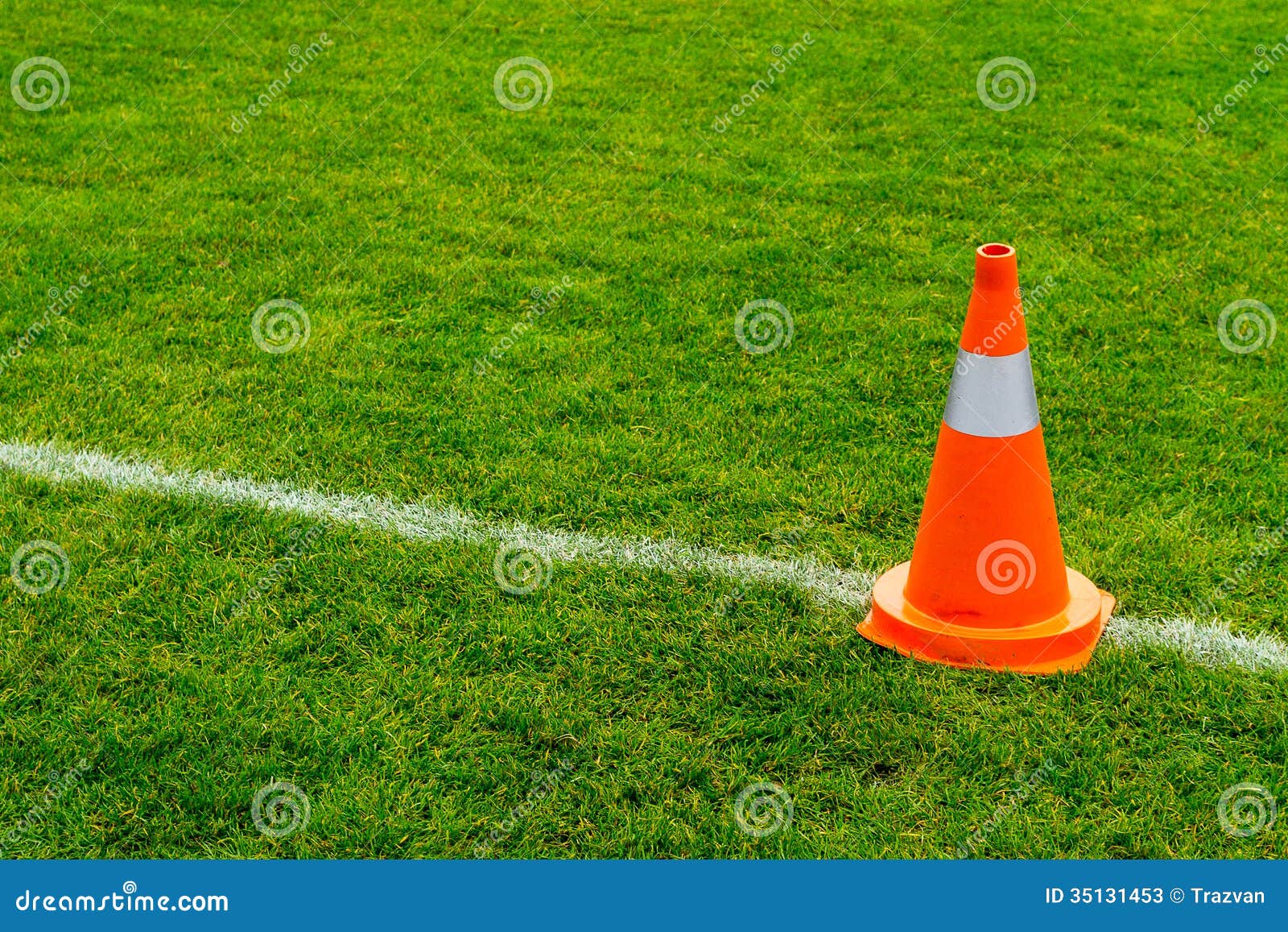 Orange cone on grass field stock image. Image of orange 35131453