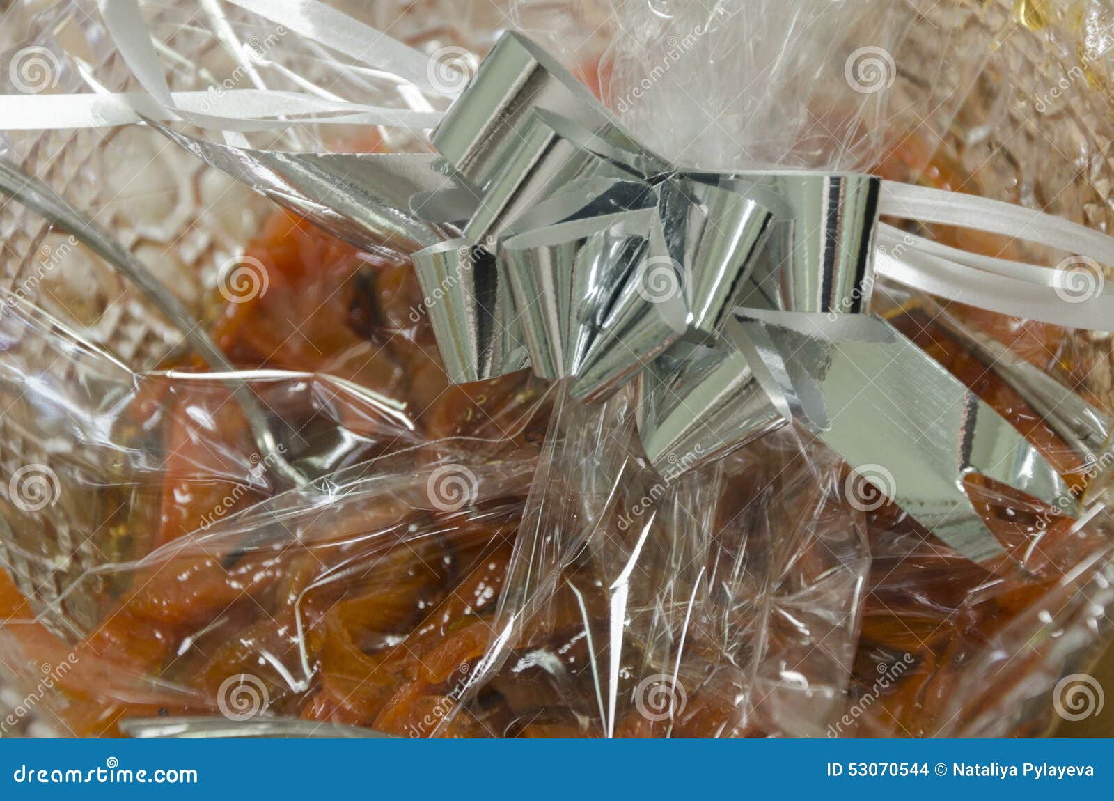 orange dried fruit and pastries in cellophane packaging -mikvah