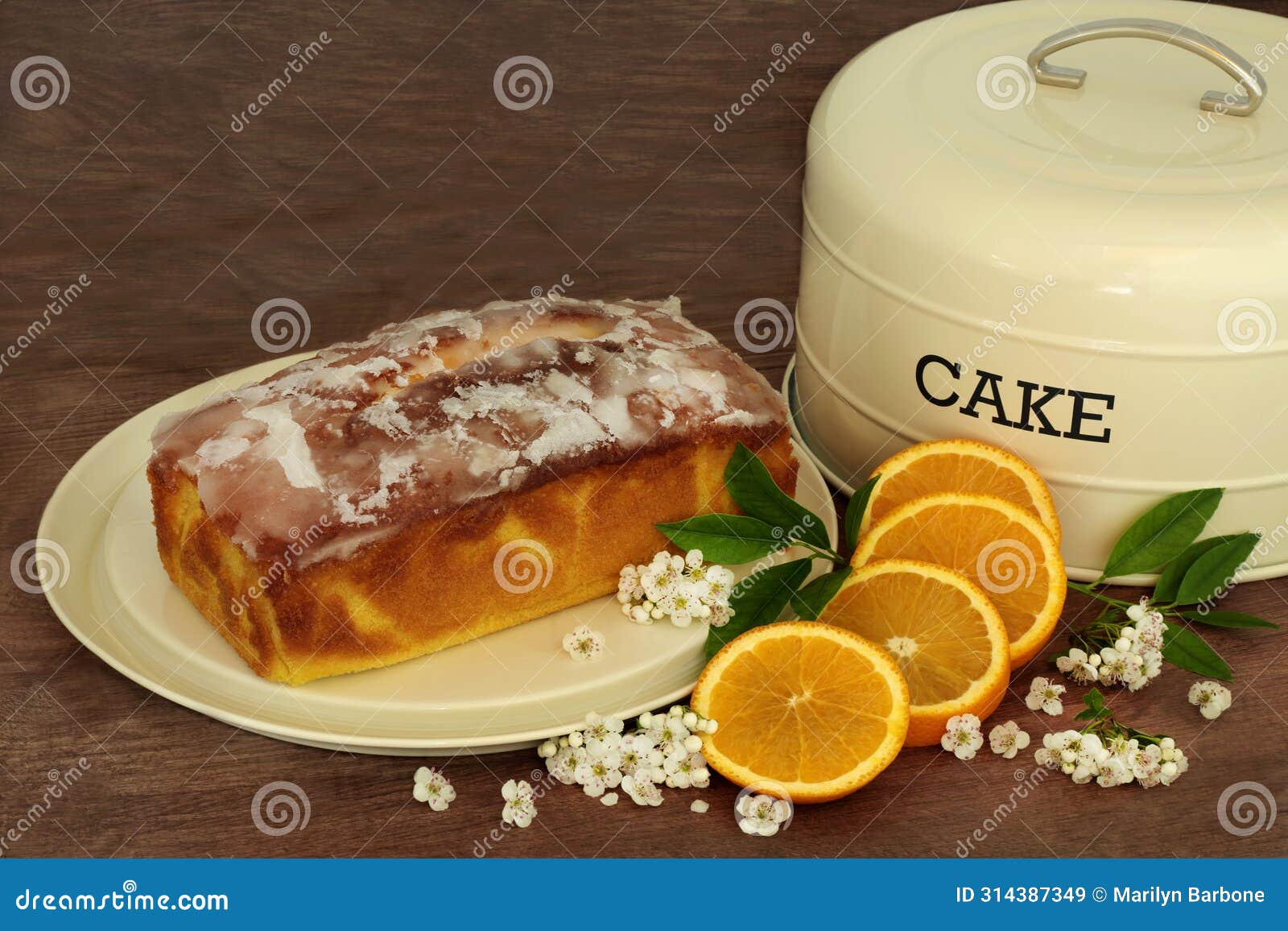 orange drizzle cake with fruit and blossom flowers