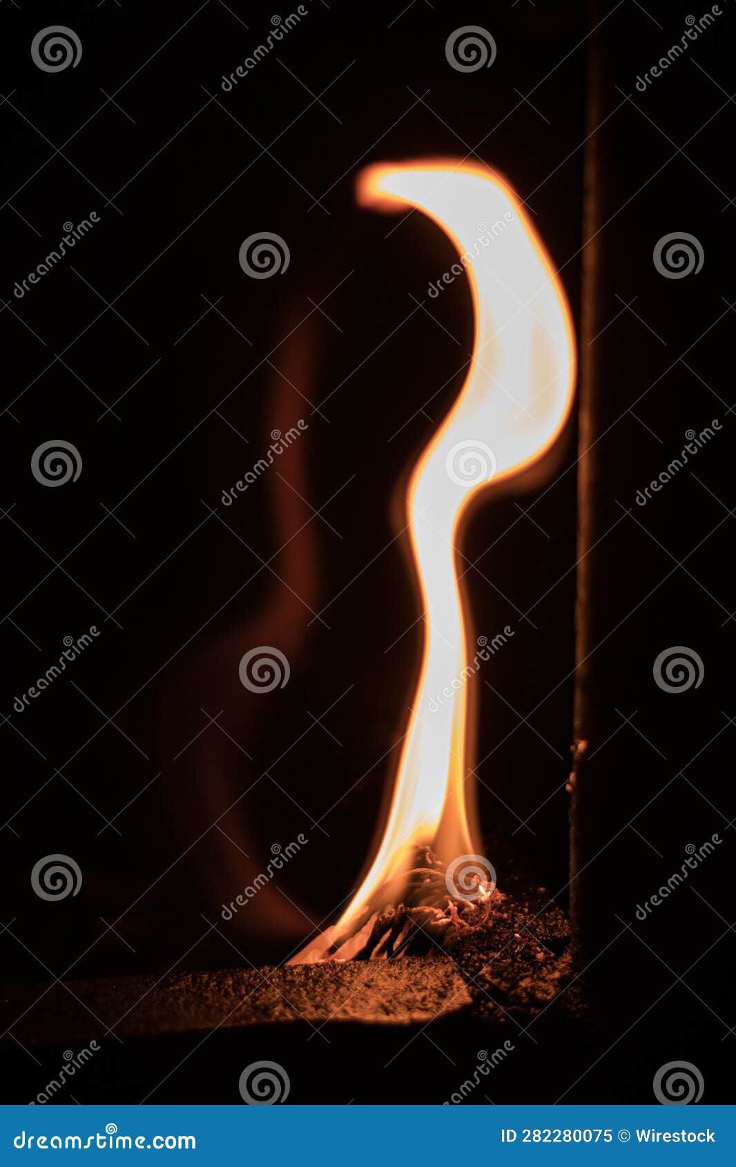 Orange, Flickering Fire is Burning Inside a Glass Bottle, Emitting a