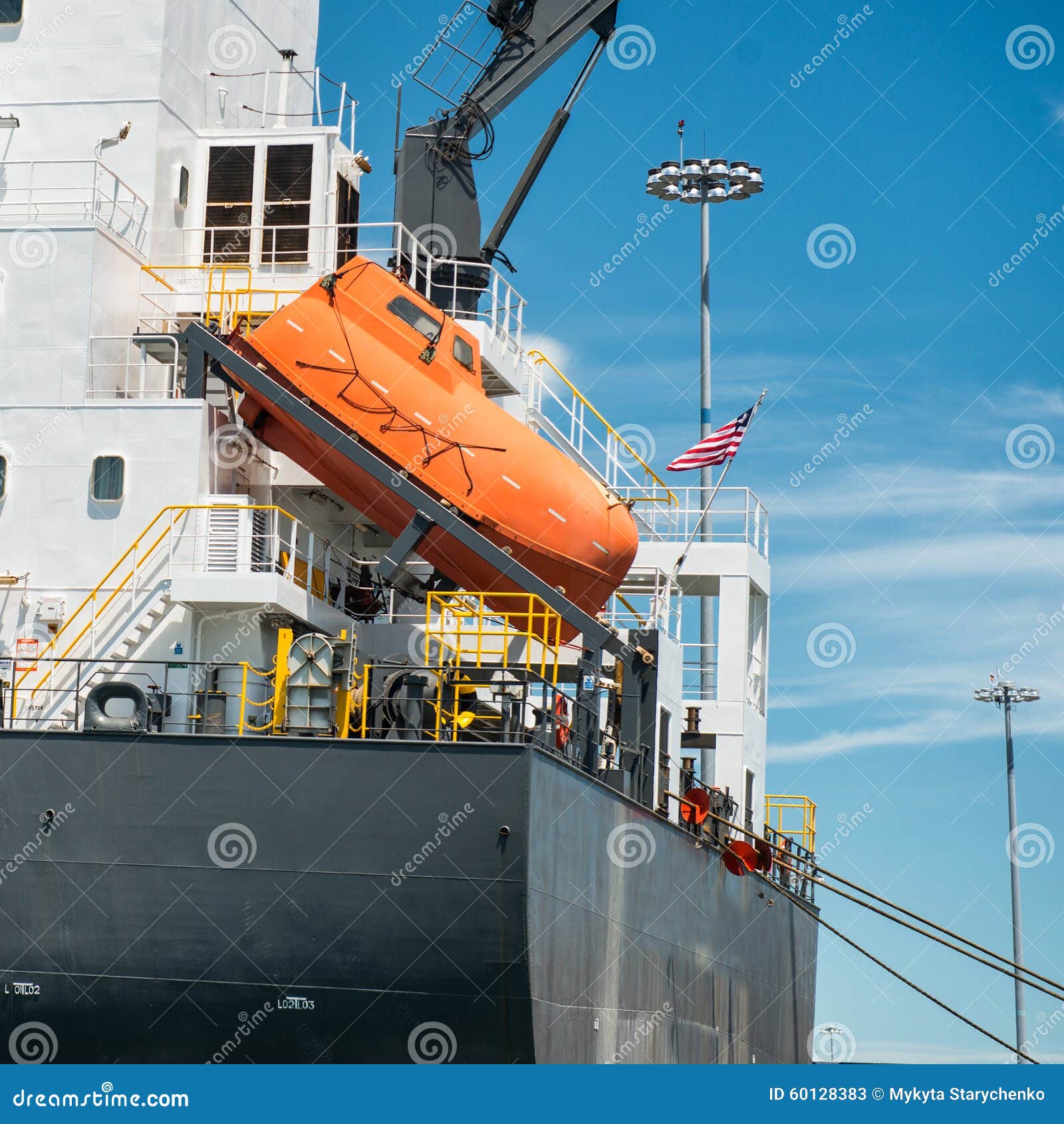 Orange free-fall life boat for emergency crew evacuation installed on 