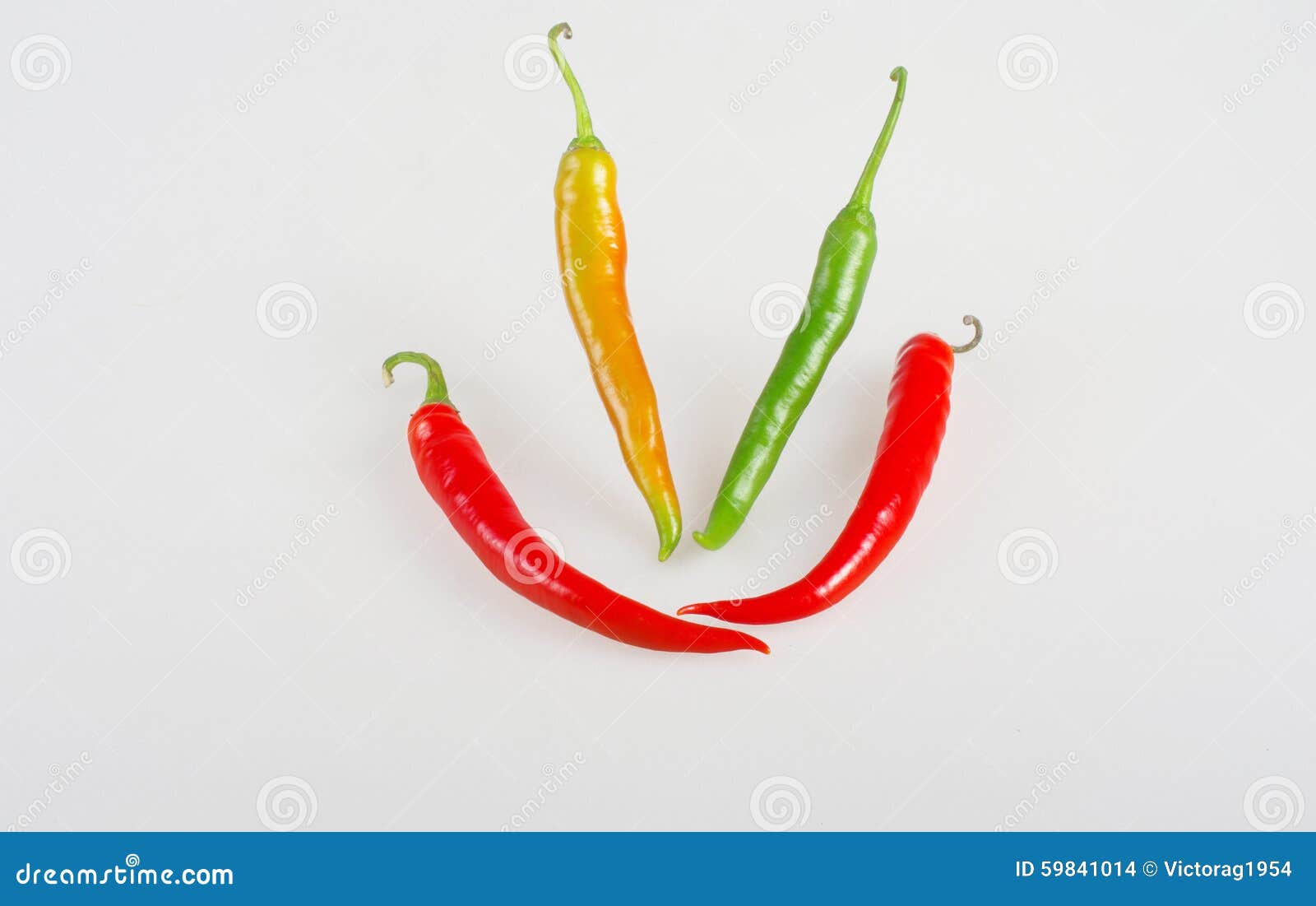 orange, green and red sweet chili peppers smiling.