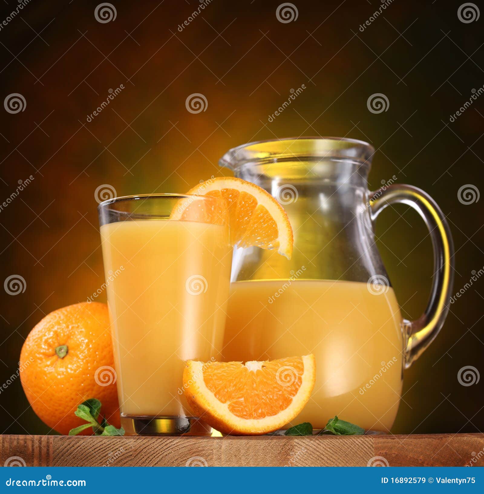 Glass Full Of Orange Juice, Carafe With Fresh Juice, Straw And Fresh  Oranges In The Background On Wooden Table Stock Photo, Picture and Royalty  Free Image. Image 105485816.