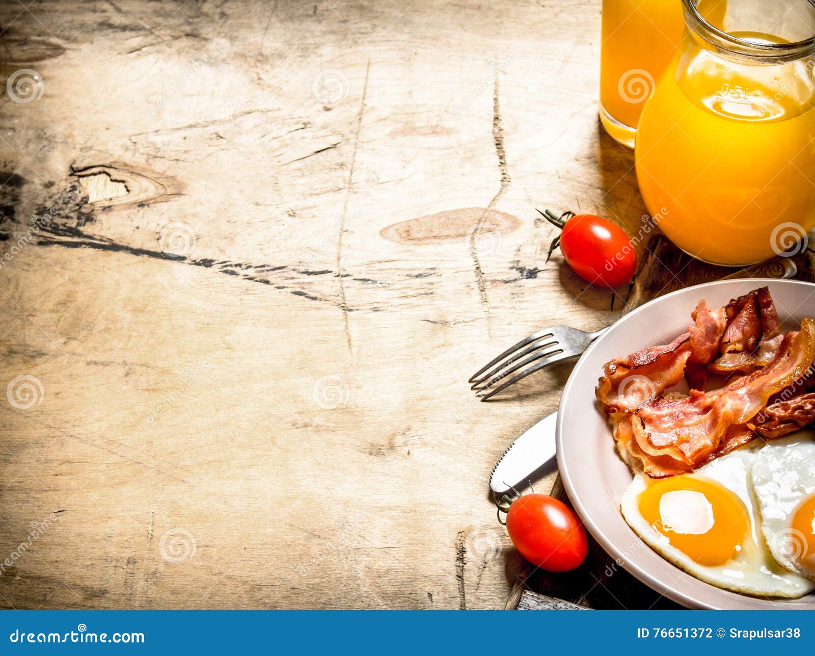 Orange Juice with Fried Eggs, Bacon, and Slices of Bread. Stock Photo