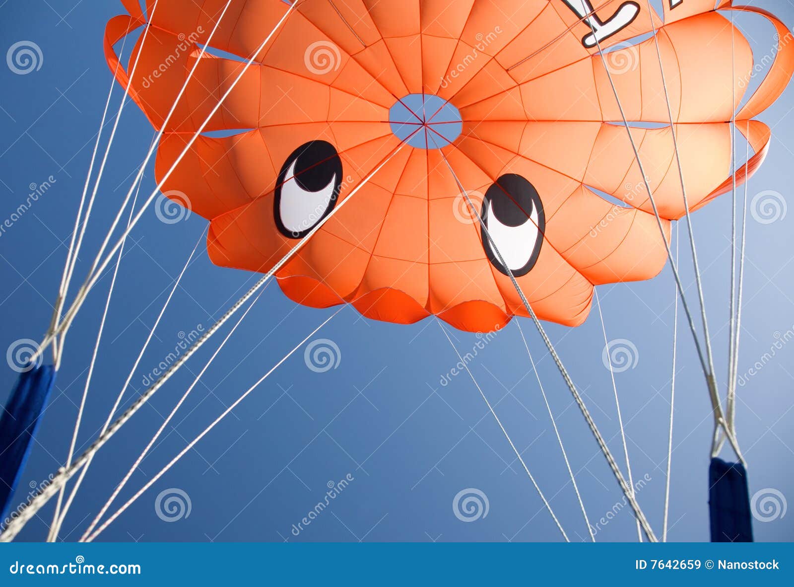 orange parasail against blue sky
