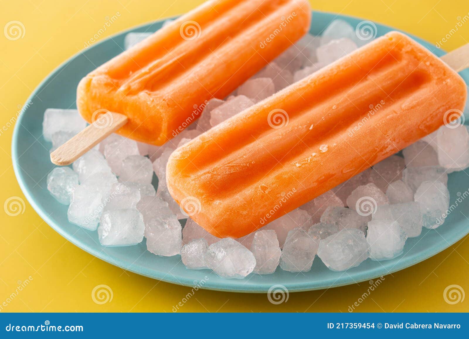 Orange Popsicles on Blue Plate Stock Photo Image of popsicle, summer 217359454