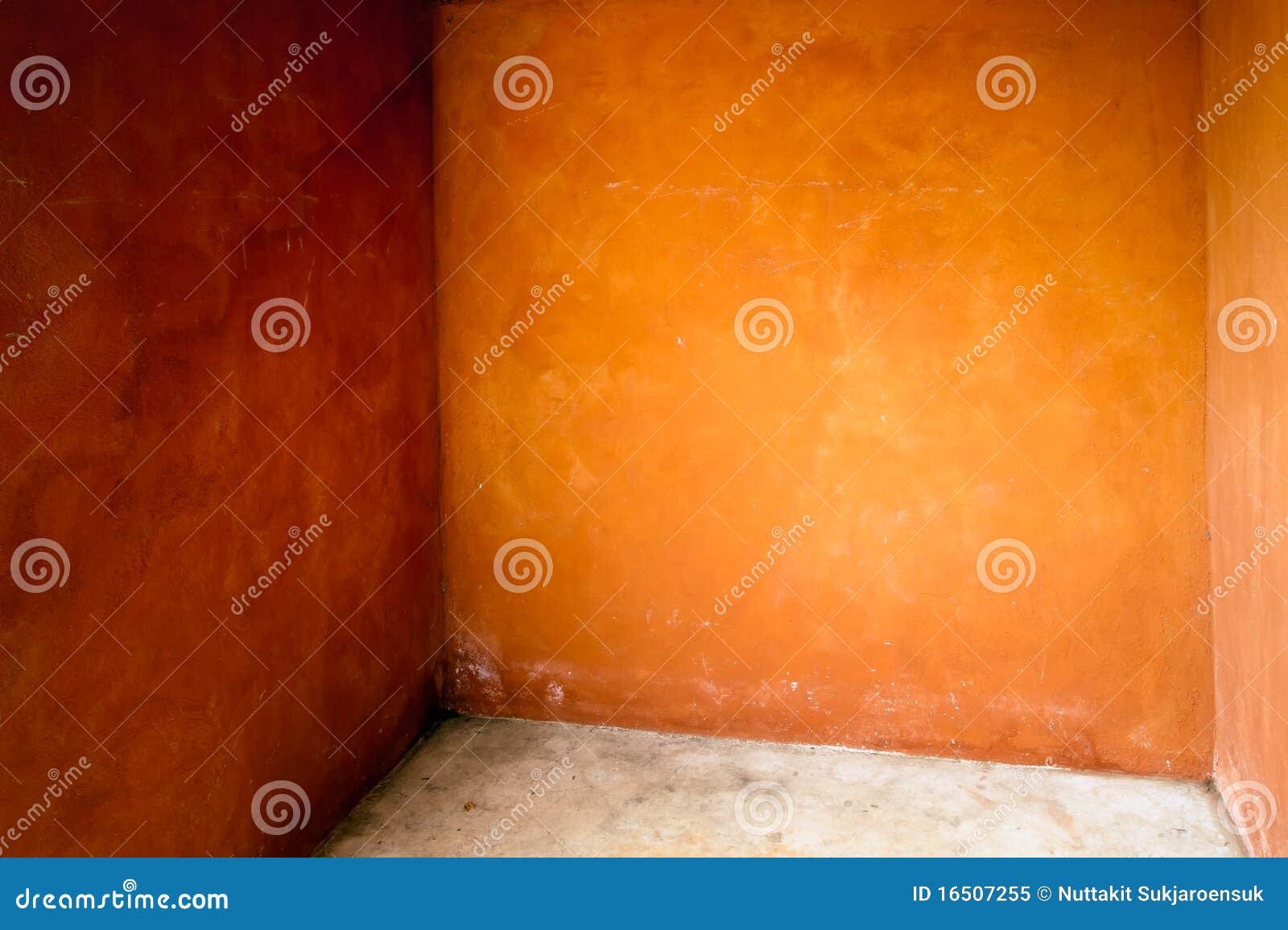 Empty corner wall and floor of orange room