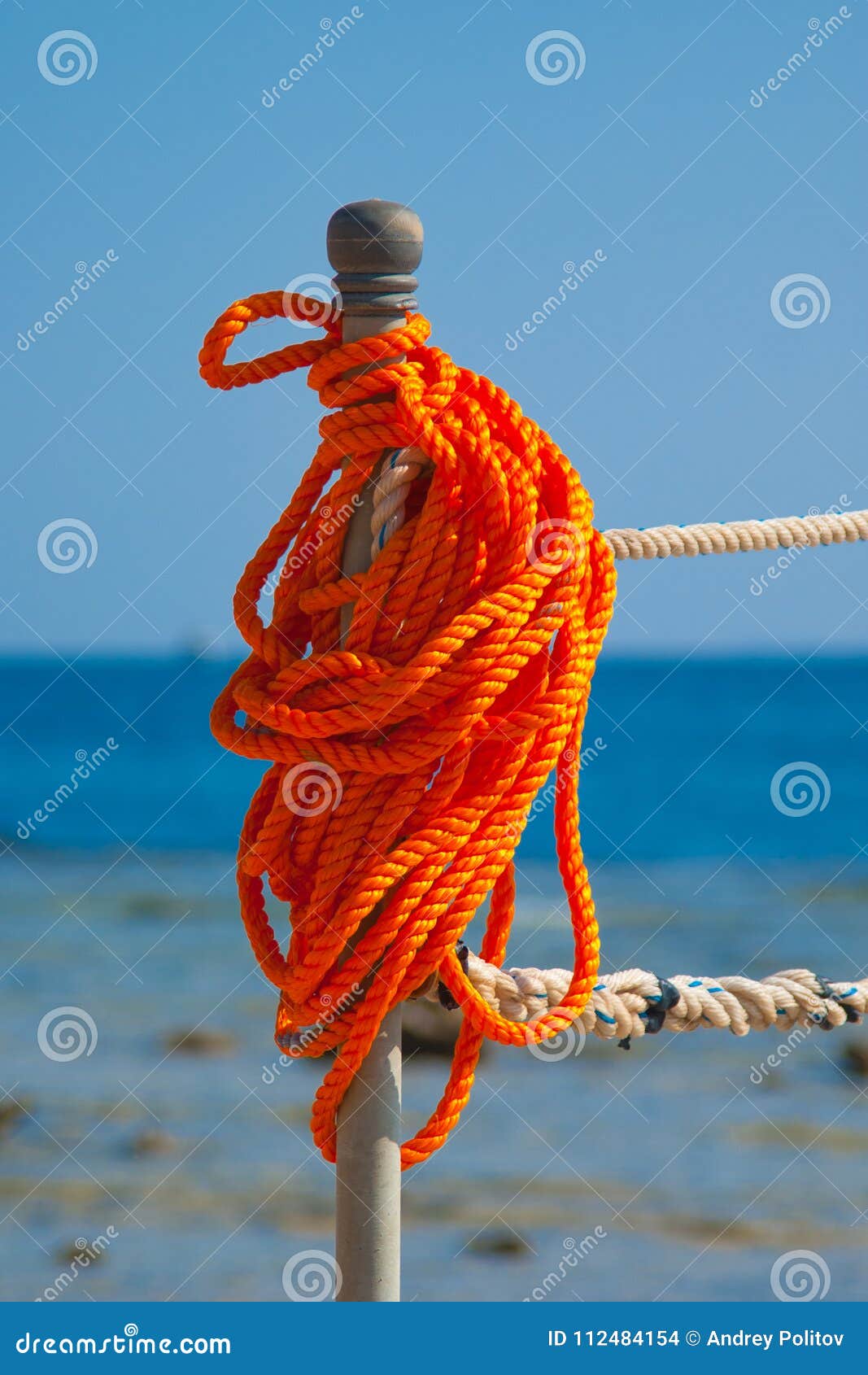 Orange safety rope on pier stock photo. Image of idyllic 112484154