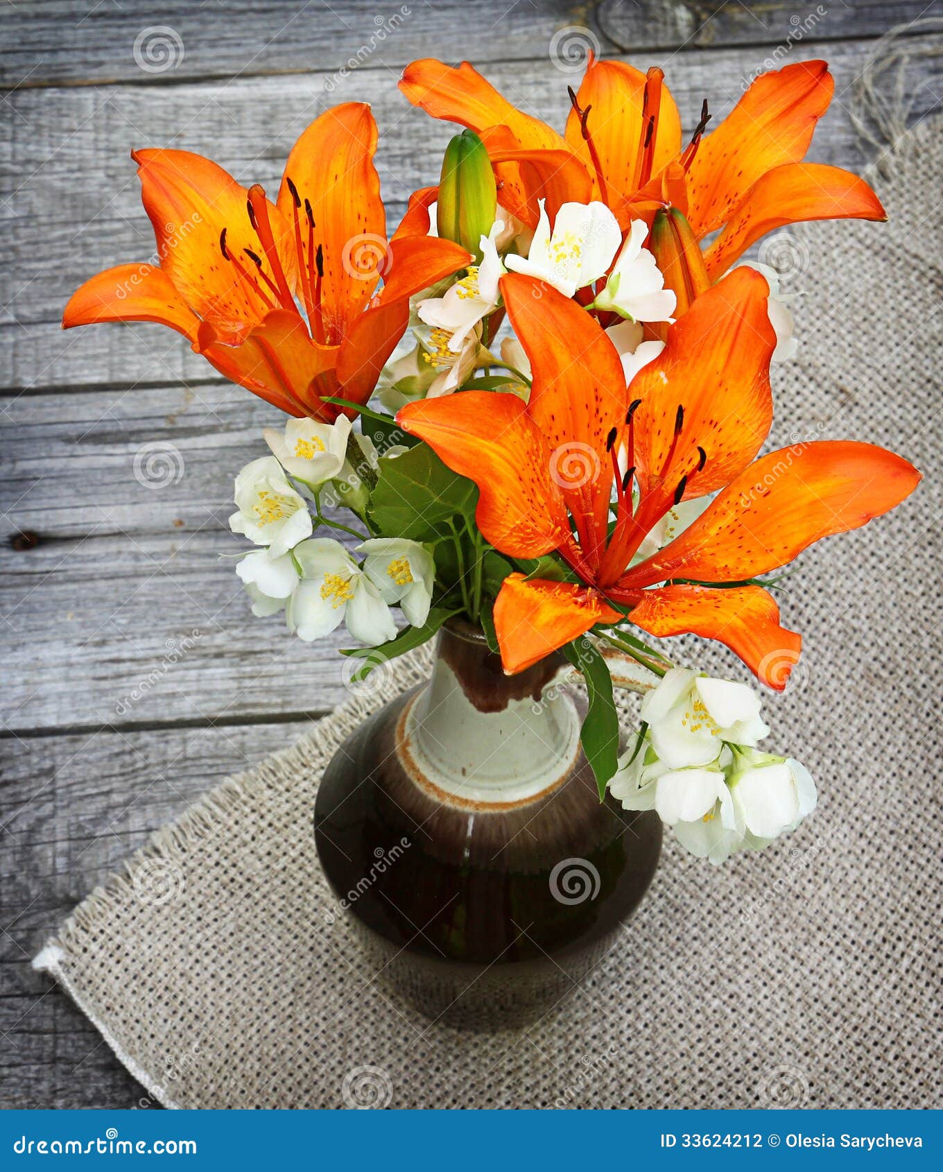 Orange Saffron Lilies And Jasmine Flowers On Wooden Table 