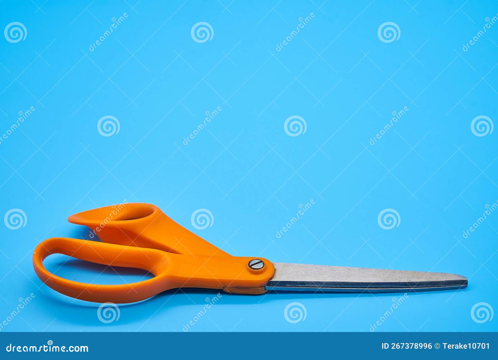 Orange Shear Scissors on a Light Blue Background Cutting Shears Stock