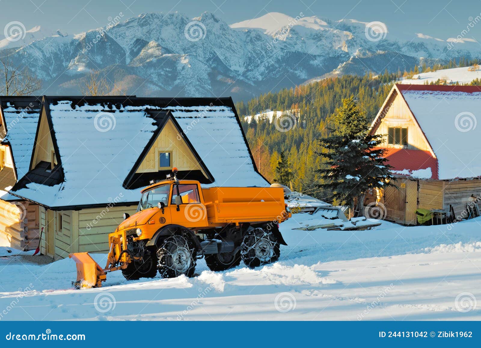 Orange Snow Plow at the Foot of the Mountains Stock Photo Image of