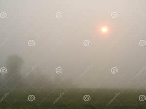 Fire Orange Sunrise Through Foggy Hillside In FingerLakes Stock Photo Fire Orange Sunrise Through Foggy Hillside In FingerLakes Stock Photo