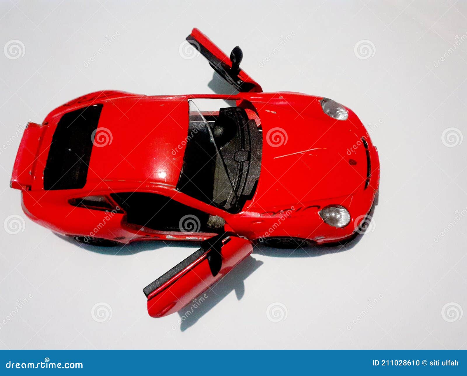 Orange Toy Car with Open Doors and Broken Windshield and White