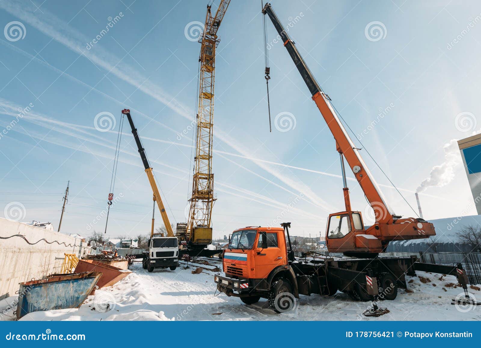 Orange Truck Crane at Work on a Construction Site in Winter Stock Image