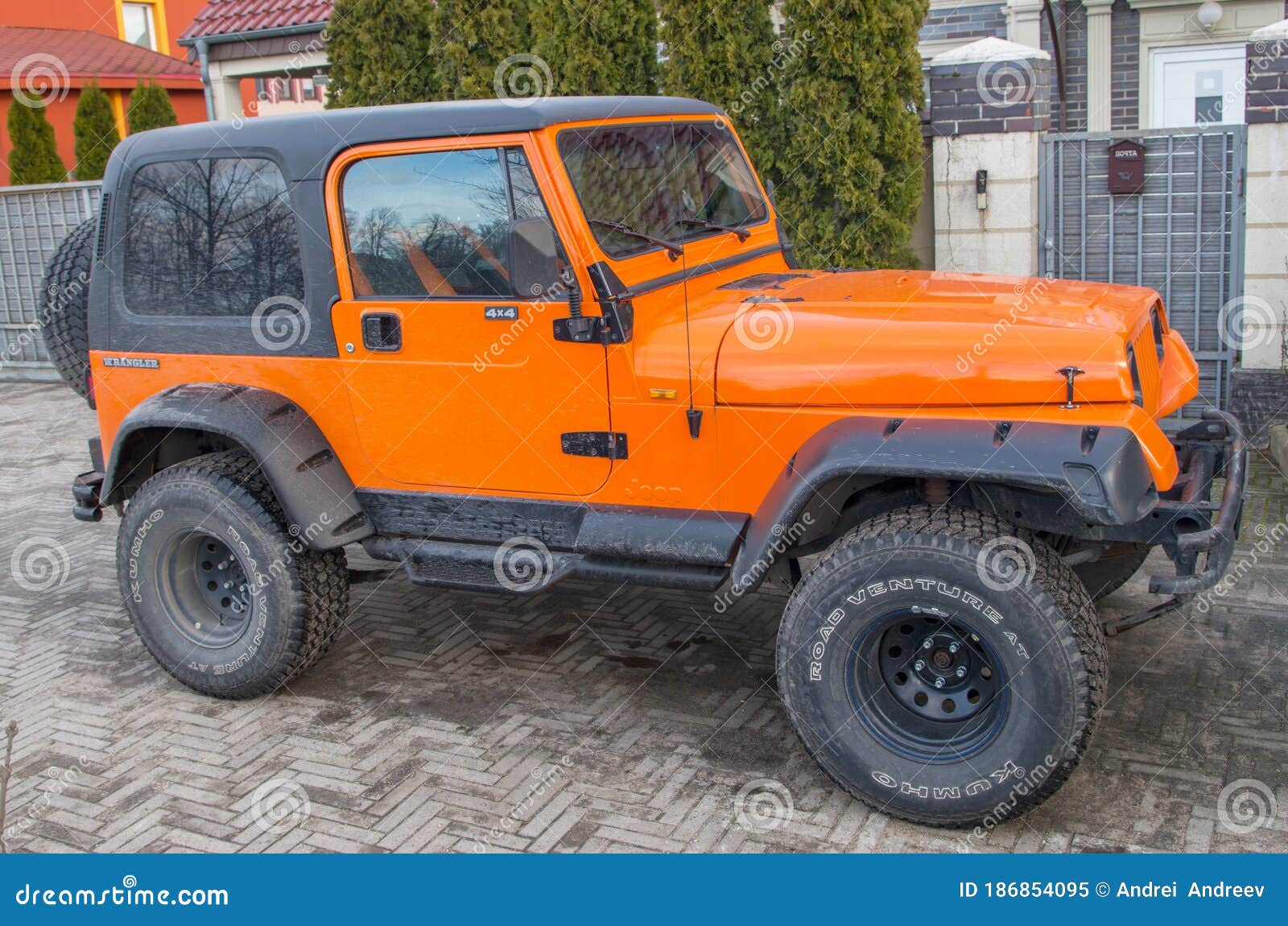 Orange Two Door Jeep Wrangler SUV with Gray Roof and Square Headlights  Standing on Gray Sidewalk Tiles in Front of House Editorial Image - Image  of kaliningrad, headlights: 186854095