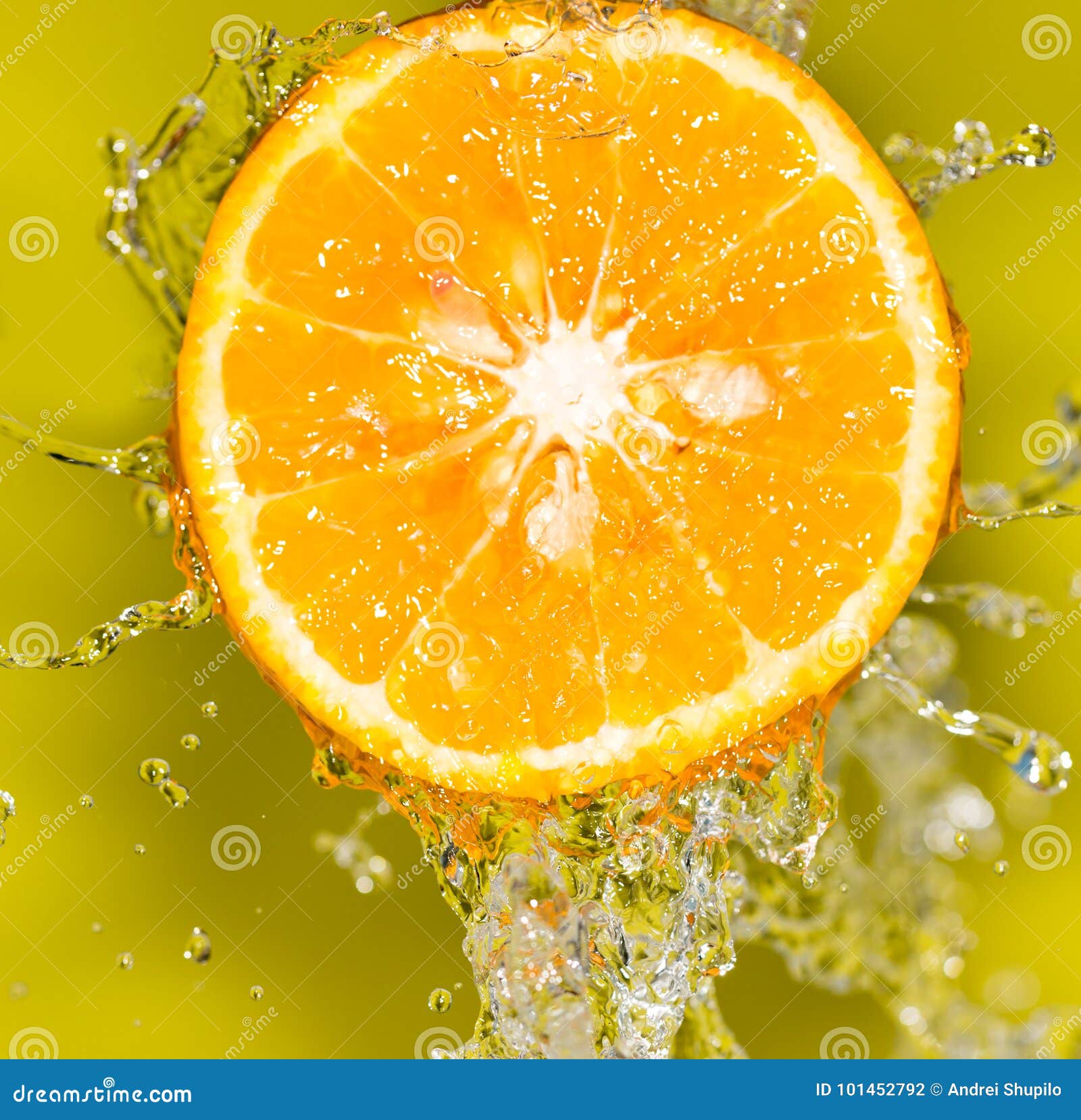 Orange in Water on a Yellow Background Background Stock Photo Image
