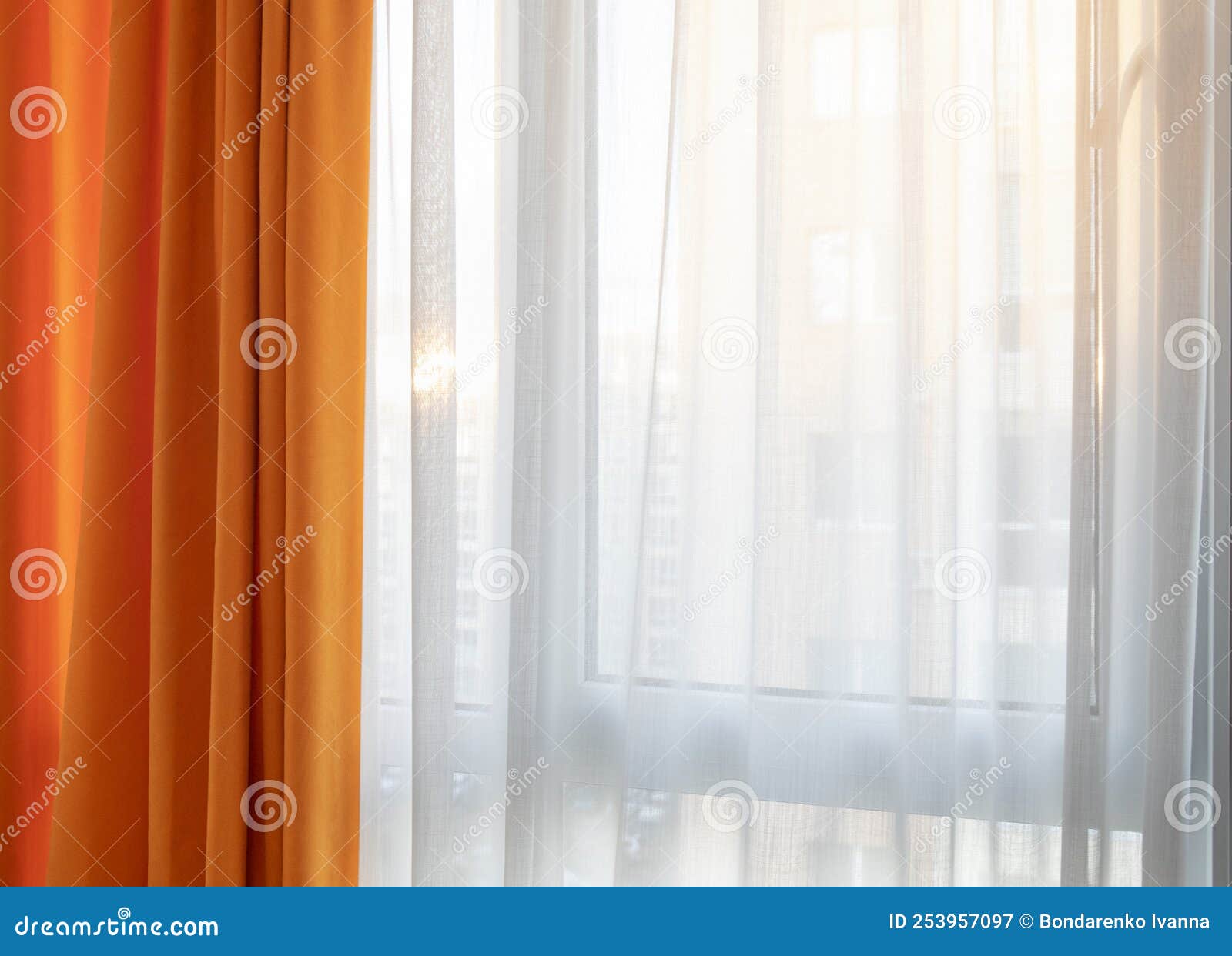 Orange and White Curtains Against Sunlights through Window Stock Image