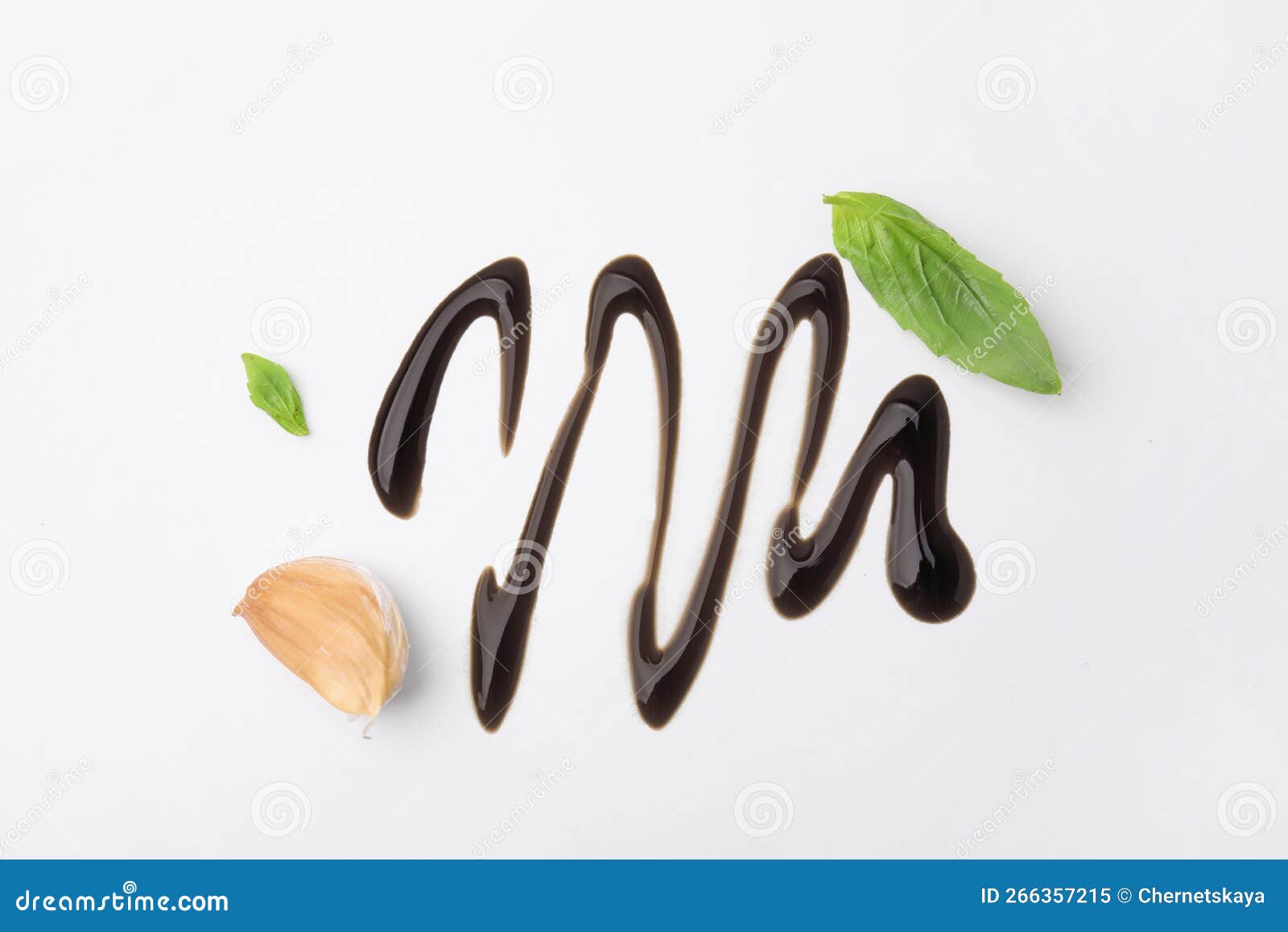 Organic Balsamic Vinegar, Garlic and Basil Leaves on White Background