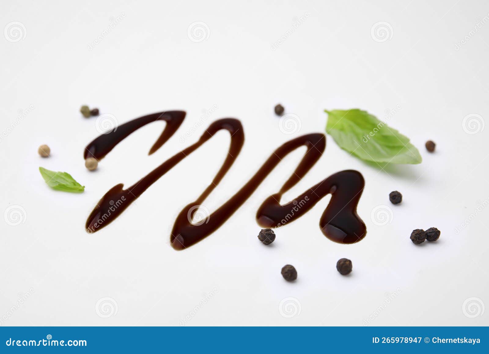 Organic Balsamic Vinegar, Peppercorns and Basil Leaves on White