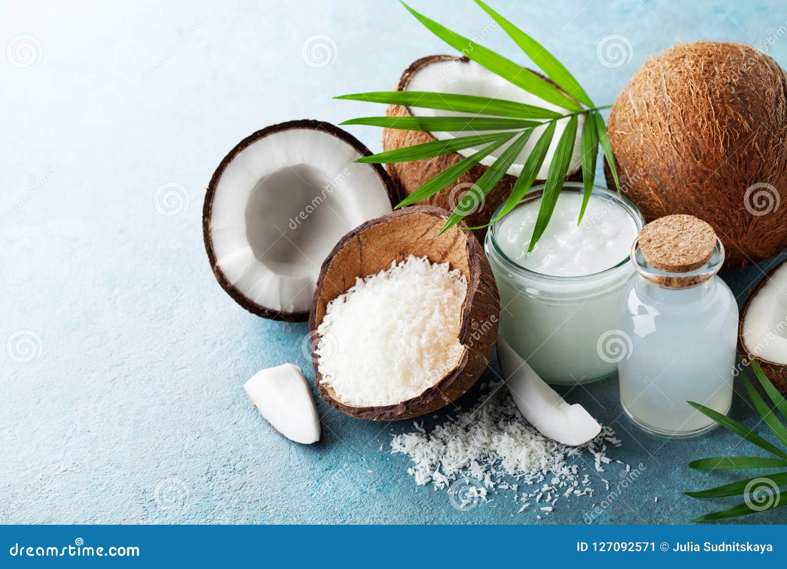 organic coconut products for spa, cosmetic or food ingredients decorated palm leaves. natural oil, water and shavings.