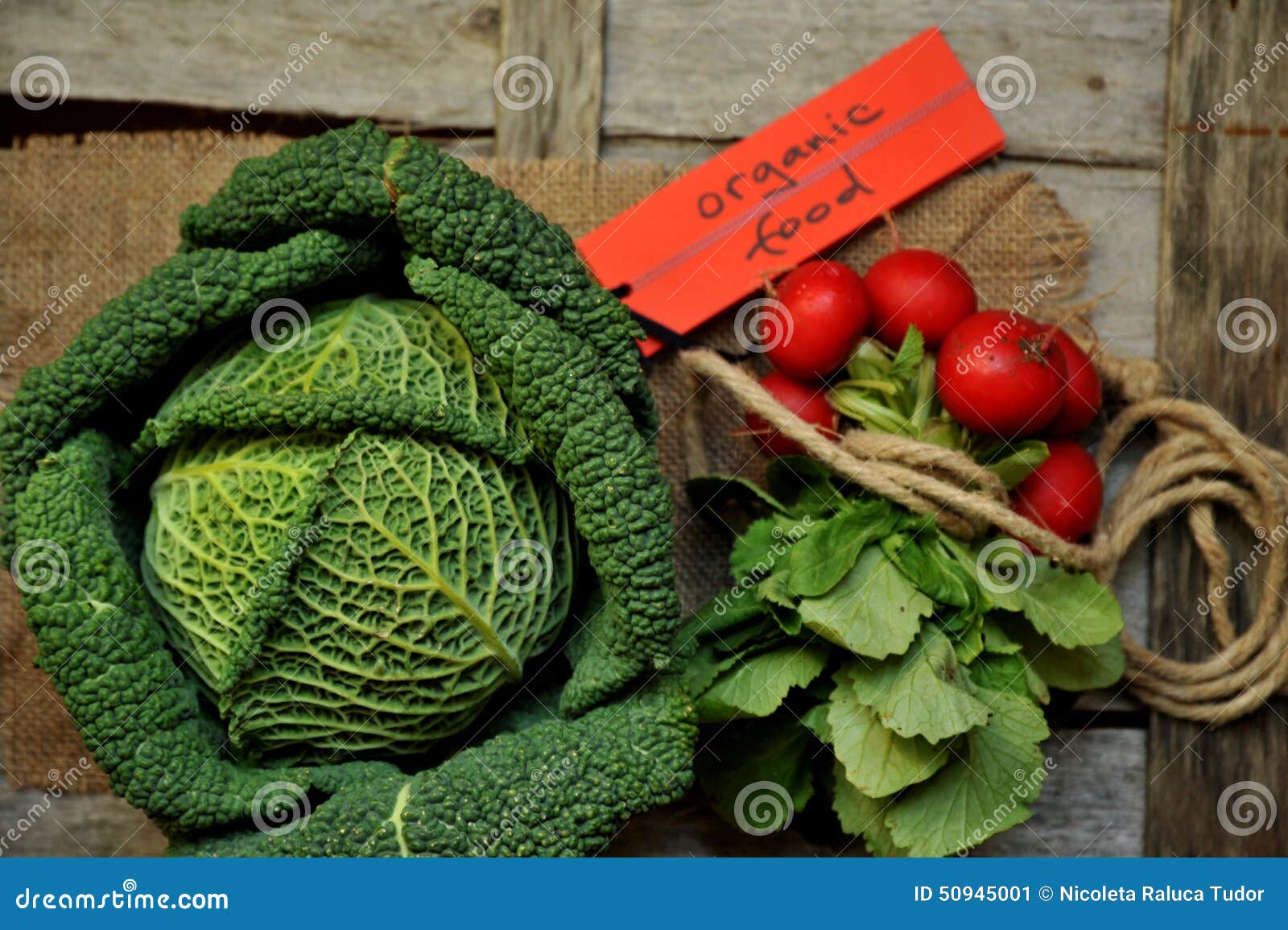 organic vegetables : green cabbage and radish on a wooden board