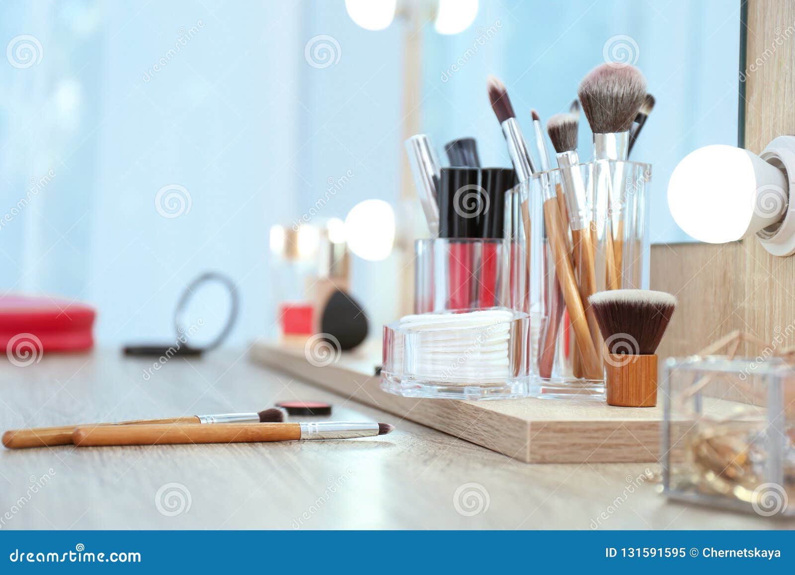 Organizer With Cosmetic Products For Makeup On Table Near Mirror