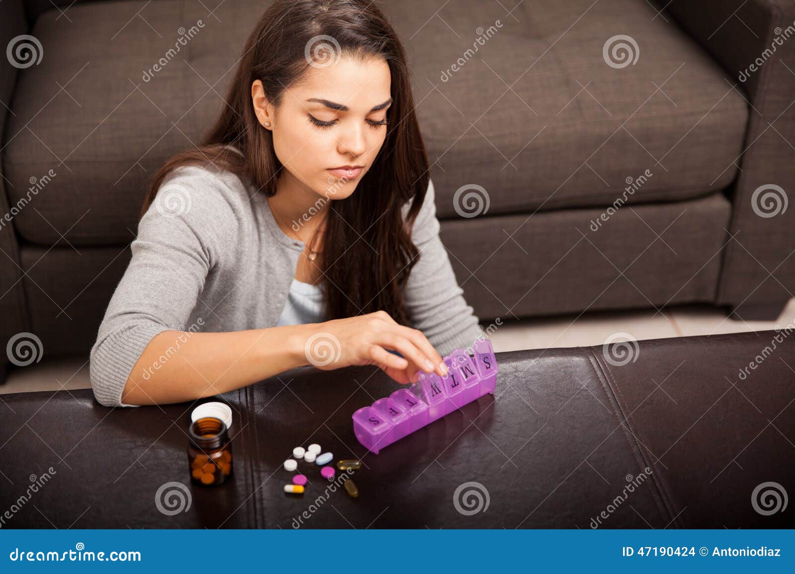 Organizing her vitamins stock photo. Image of health 47190424
