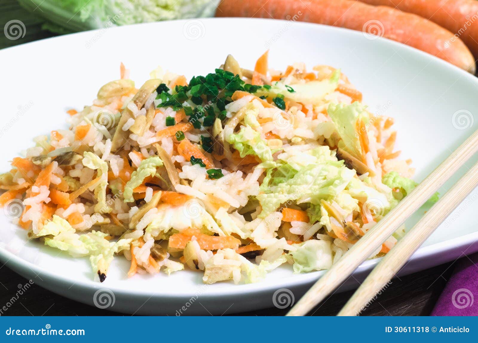 Oriental rice salad. Close view of a dish of rice salad with chinese cabbage, rice and roasted almonds