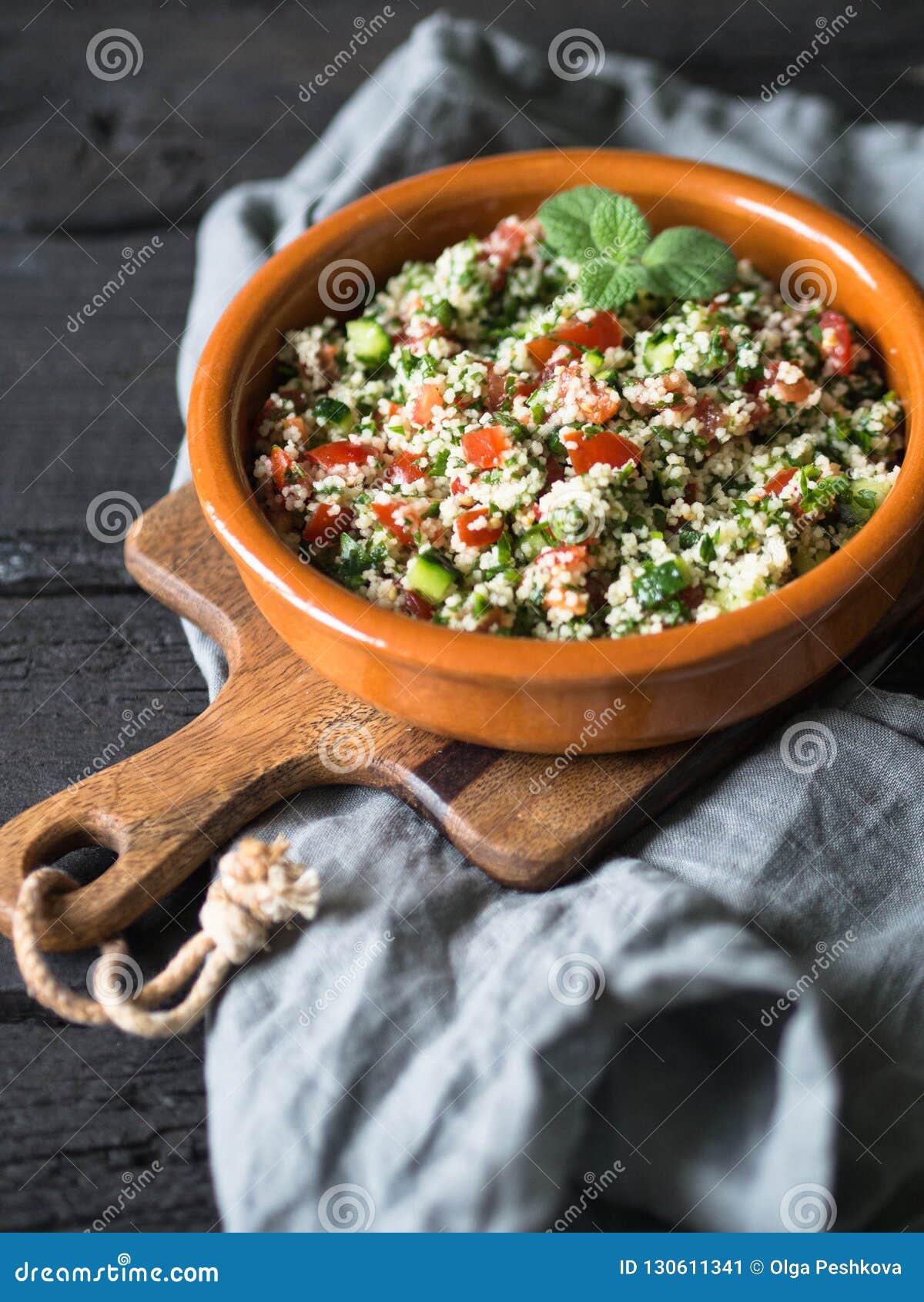 Oriental Tabbouleh Salad with Couscous, Vegetables and Herbs in a Brown ...