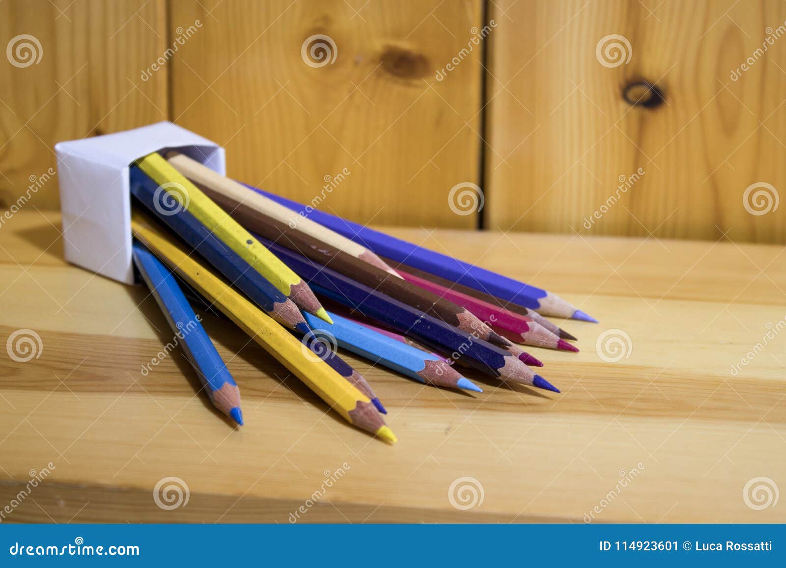 Origami, Colored Pencils Inside a Paper Box on a Wood Shelf Stock Image