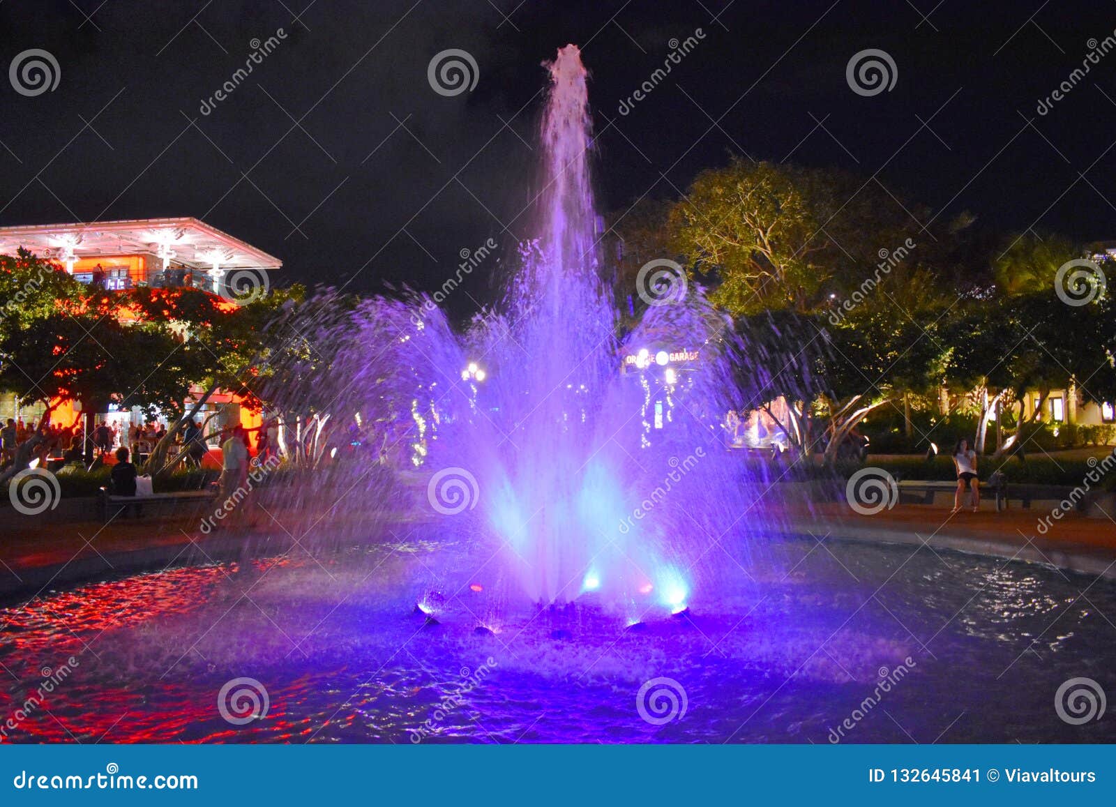 Illuminated Water Fountain Of Purple Color At Lake Buena Vista