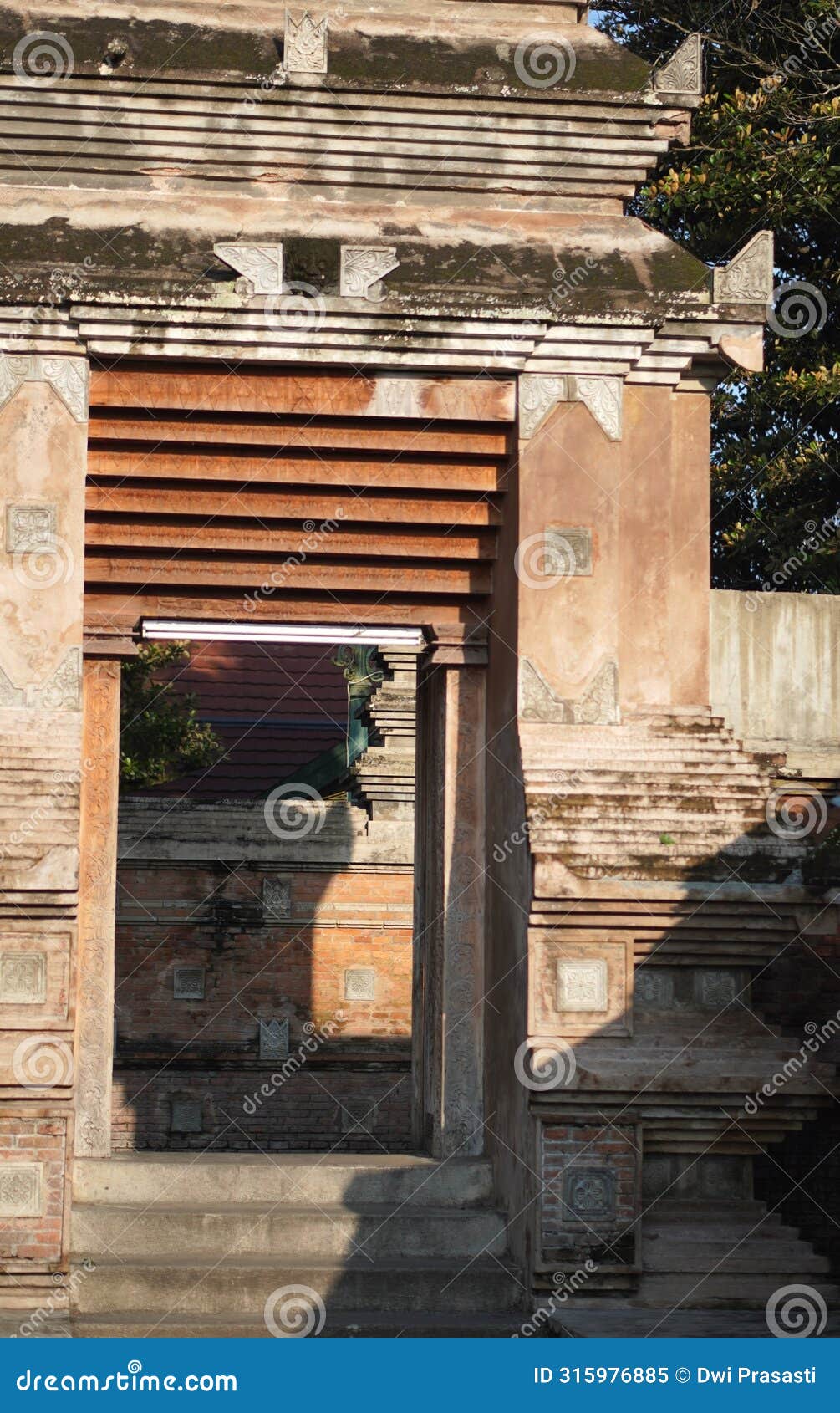 an ornate gate at a cultural heritage cemetery in yogyakarta, made from red brick