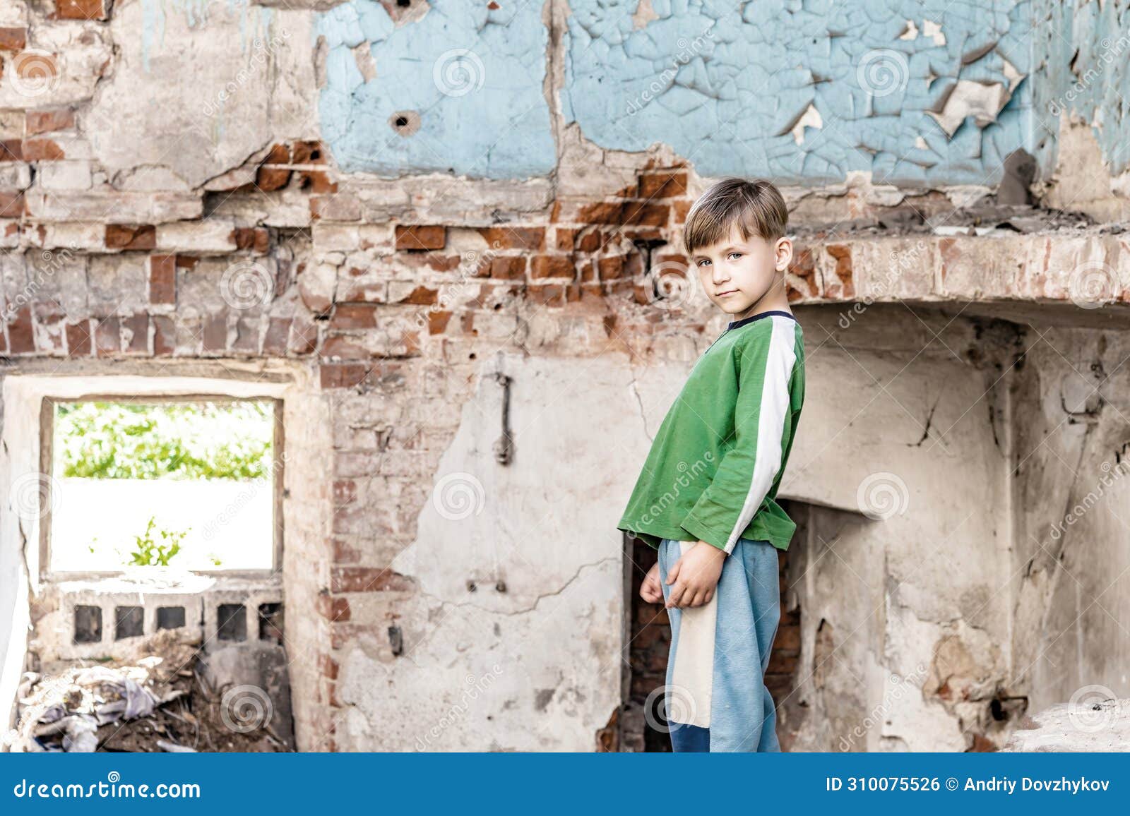 orphaned children, poor child standing in a destroyed and abandoned building, staged photo