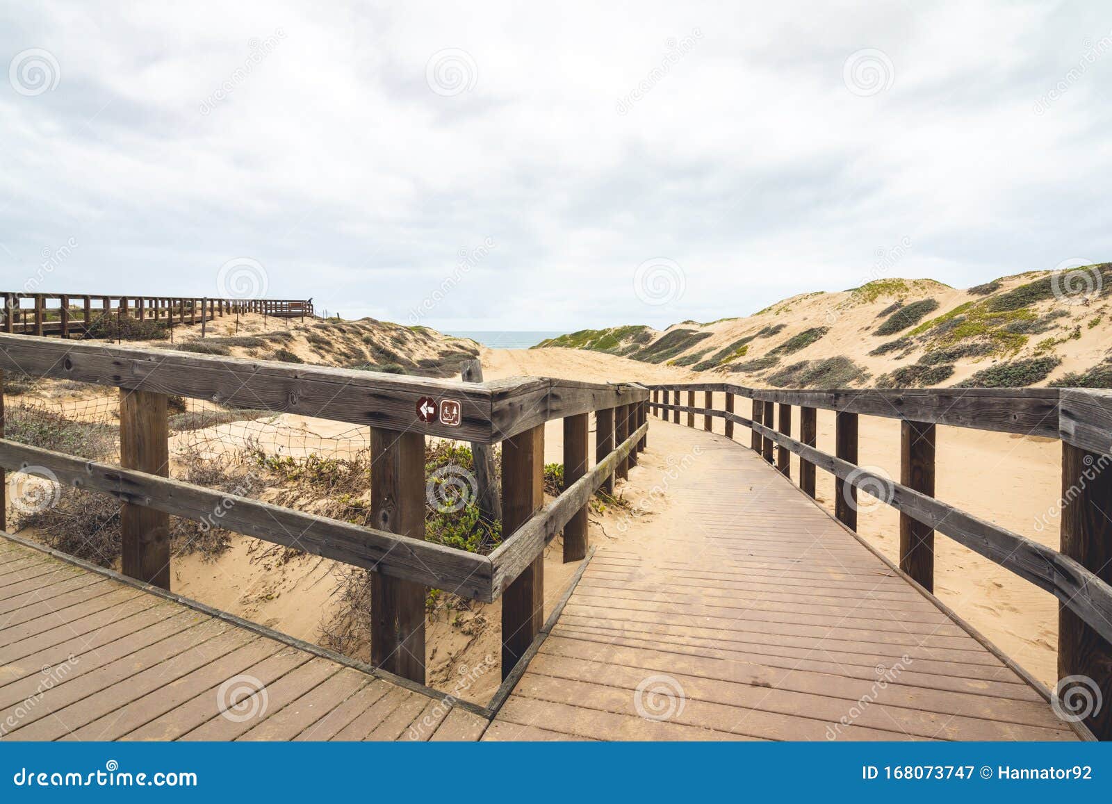 wooden boardwalk through sand dunes. oceano, california