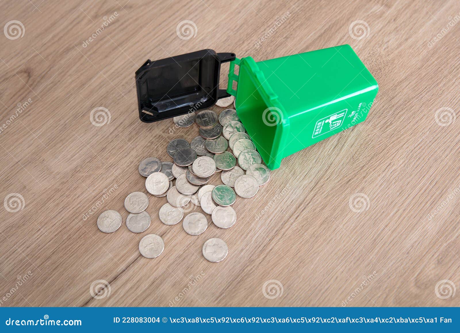 the other trash bin was scattered a lot of dollar coins.the chinese characters on the trash can mean`kitchen waste`and`everyone is