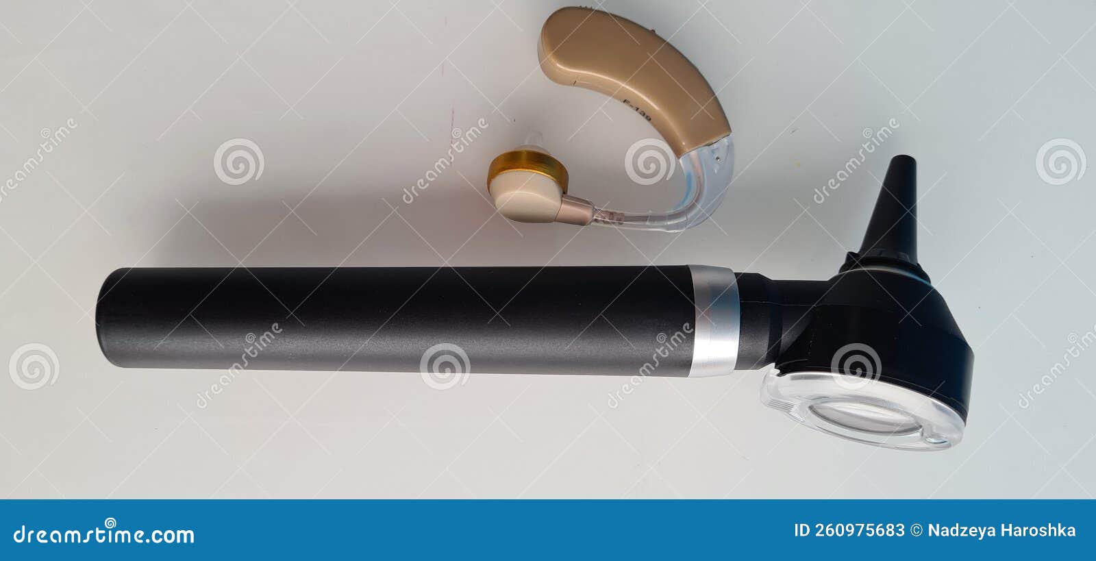 Otoscope and Hearing Aid for Ear on White Background Stock Image