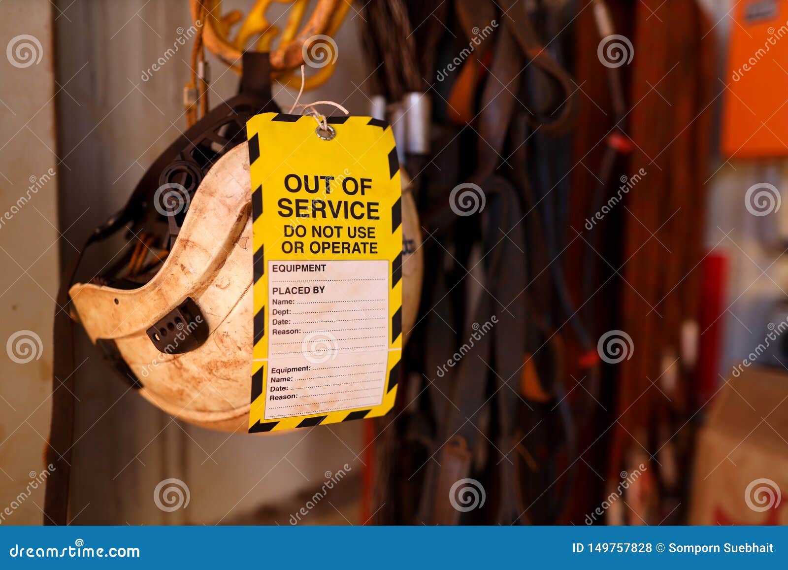 out of service tag attached on faulty defect safety fall protection abseiling helmet