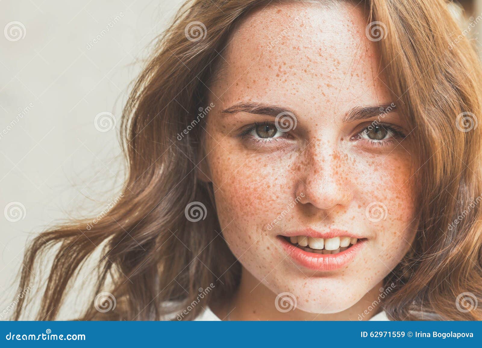 outdoor beauty. portrait of smiling young and happy woman with freckles.
