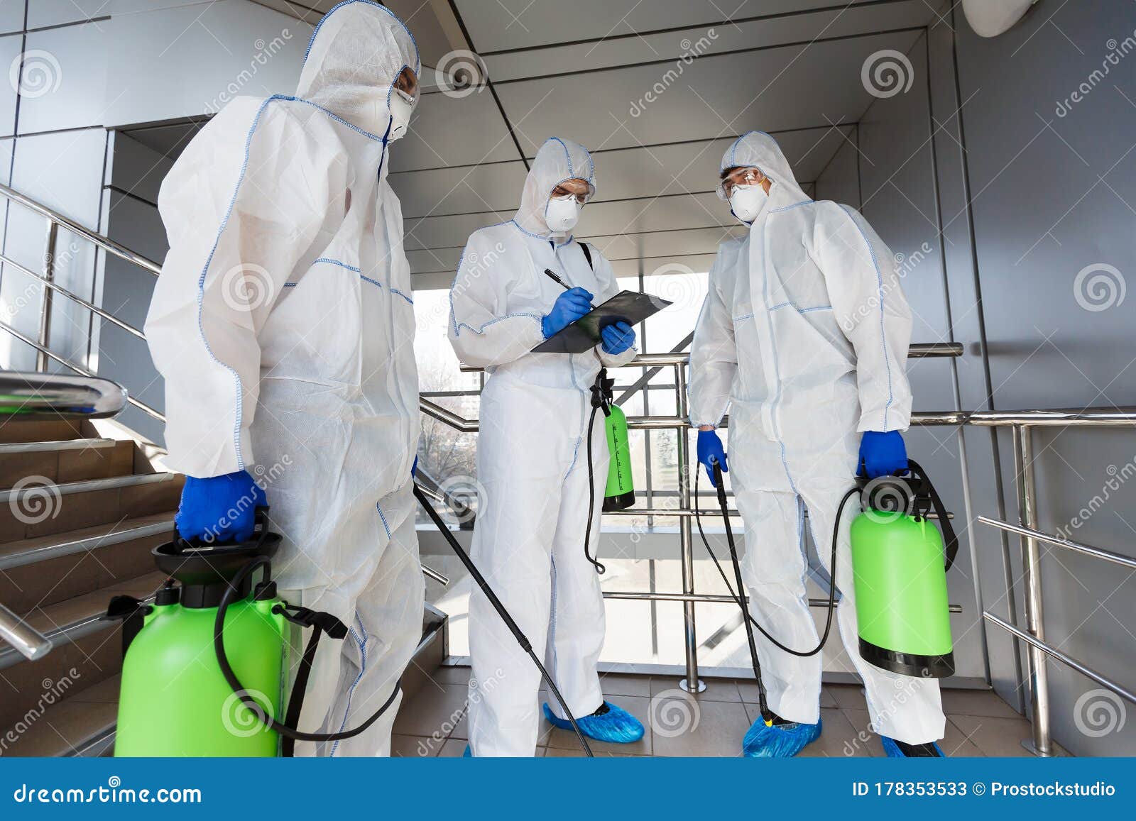 outdoor disinfection by cleaning workers in hazmat suits