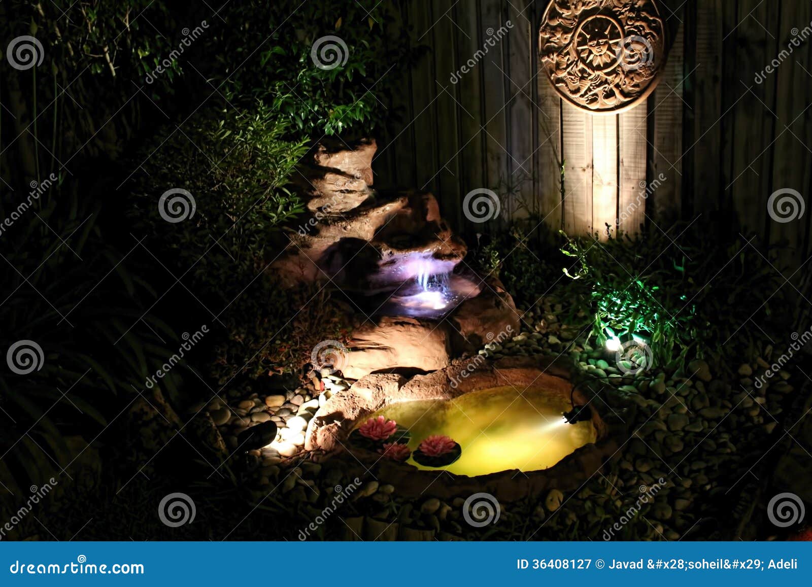 outdoor garden with water feature fishpond at nigh