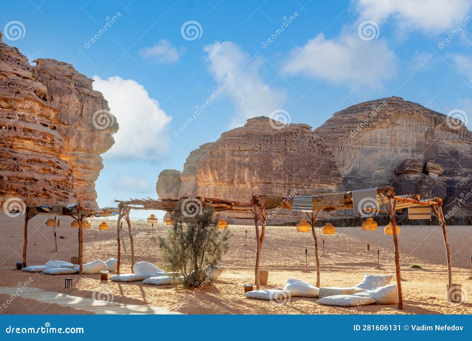 outdoor lounge in front of elephant rock erosion monolith standing in the desert, al ula, saudi arabia
