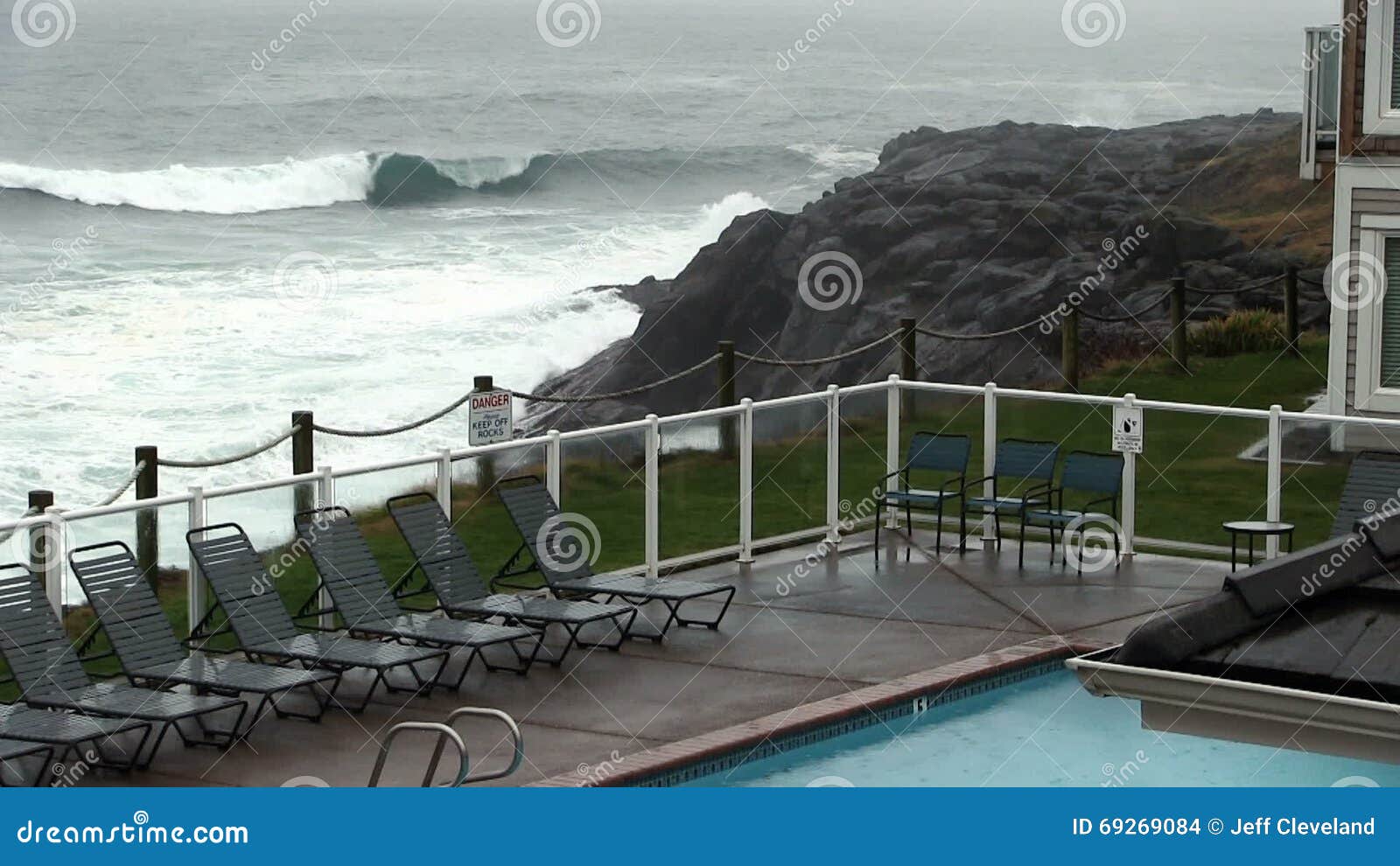 Outdoor Pool in Rain with Ocean Waves Hitting Coast Stock Footage