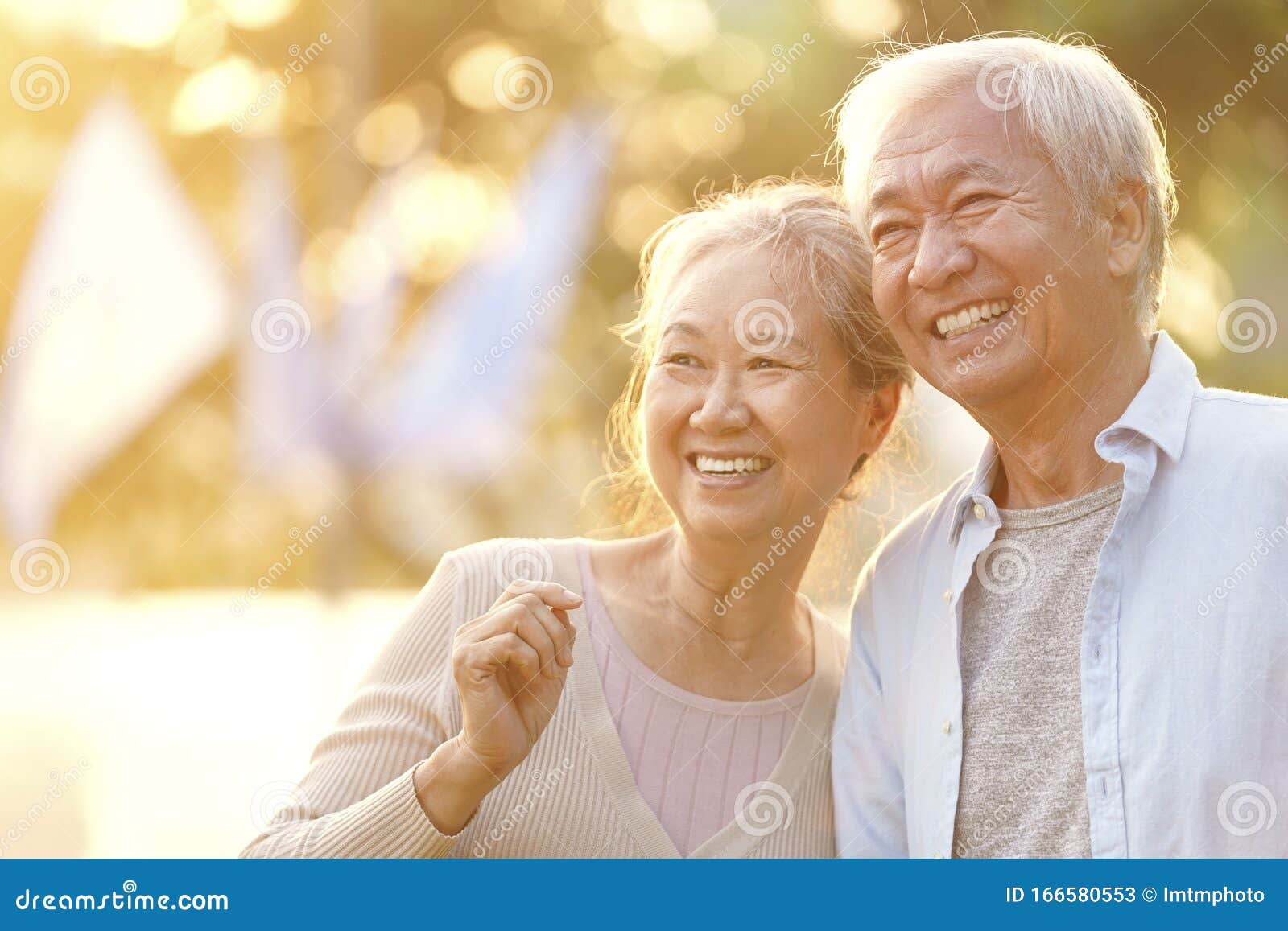 outdoor portrait of happy senior asian couple