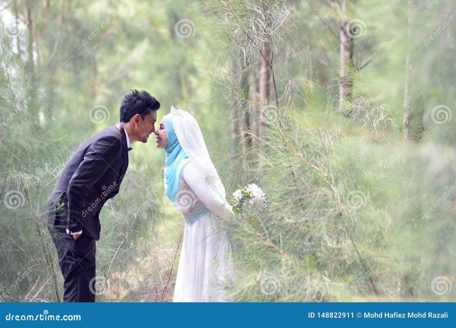 Outdoor Portrait Of A Lovely Malay Wedding Couple In A Beautiful