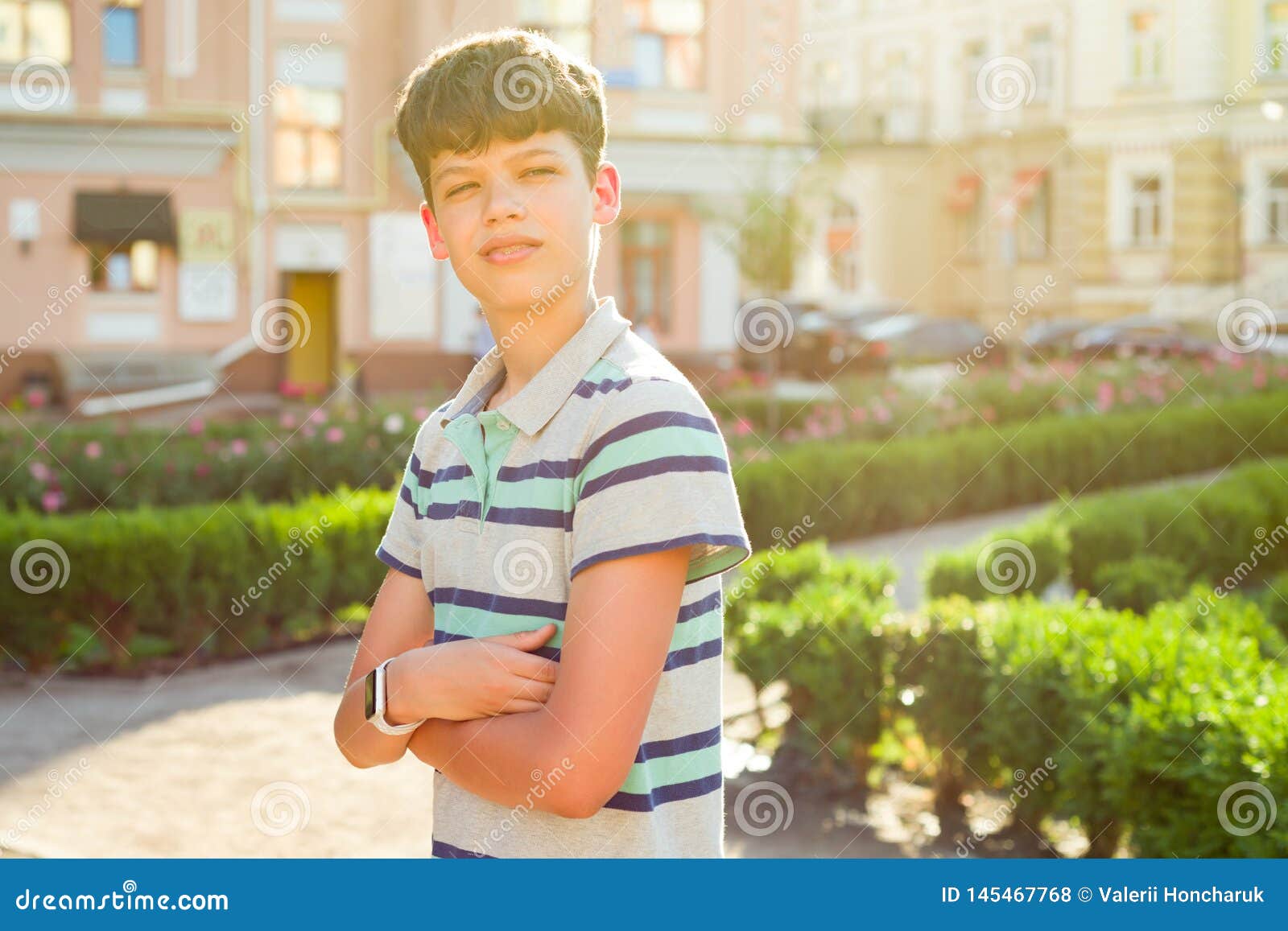 Outdoor Portrait Of Teenager 13, 14 Years Old, Boy With Crossed Arms