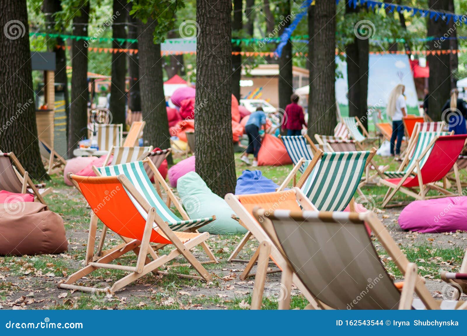 Outdoor Recreation Area With A Many Colorful Soft Chair Bags Wooden Tables And Striped Folding Wooden Chairs In A Park Stock Photo Image Of Area Beautiful 162543544