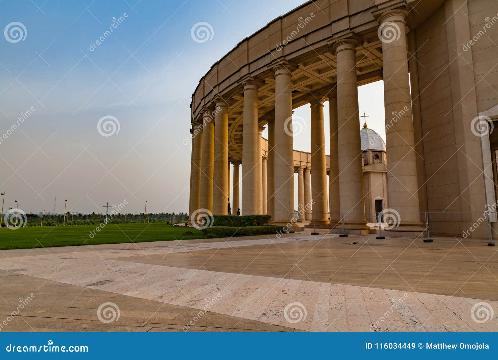 outer view of one of the colonnades of the basilica of our lady of peace with the setting sun to the west